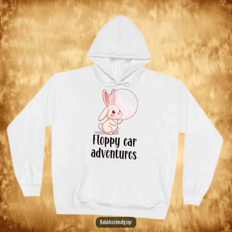 Funny hoodie with a rabbit character with floppy ears attempting to catch a large bubble, a cozy and humorous design for playful souls.